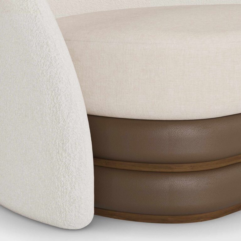 Beige and cream luxury sofa with a brown base and patterned cushions, designed by Nolita Harbour. detail view