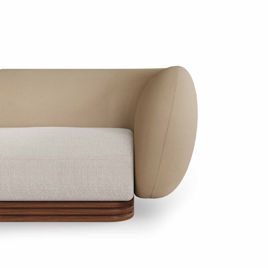 Curved sectional sofa with taupe leather upholstery, cream fabric seat cushions, and a walnut base, designed by Nolita Harbour. Detail view