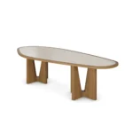 Modern dining table with a travertine top and varnished oak legs, featuring an organic-shaped tabletop and a sculptural base, by Nolita Harbour. 45 degree