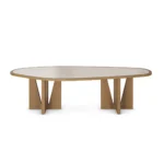 Modern dining table with a travertine top and varnished oak legs, featuring an organic-shaped tabletop and a sculptural base, by Nolita Harbour. front view