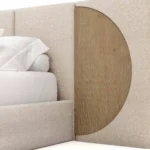 Claude Bed, a contemporary bed by Nolita Harbour in carved oak and bouclé, with an elegant tall headboard.