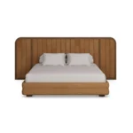 Marthina Bed by Nolita Harbour, an upholstered bed in velvet with a curved walnut headboard and a soft sculptural form.