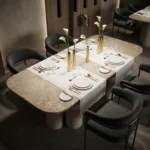 Set Petra dining table, by Nolita Harbour, with a profile that supports a handcrafted stone table for elegant dining spaces.