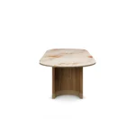 Coralie Dining Table, a modern dining table by Nolita Harbour in Aegean Rose marble and wood, with soft veining.