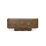 Ninon walnut sideboard with travertine top, ribbed base, and brass handles. Front view