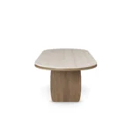Assia II Dining Table, a sculptural dining table by Nolita Harbour in travertine and walnut, with a grounded form.