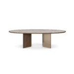 Bari Dining Table, a sculptural dining table by Nolita Harbour in marble, walnut, and brass, with a soft oval profile.