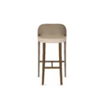 Dini bar stool by Nolita Harbour, upholstered seat with solid wood base and slim metal footrest, sculptural modern silhouette.