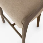 Dini upholstered bar chair detail by Nolita Harbour, wood frame stool with curved backrest and sleek architectural profile.