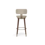 Rondi designer bar chair by Nolita Harbour, velvet bar stool with sculptural walnut frame, curved back, and metal footrest.