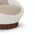 Anki velvet armchair detail by Nolita Harbour, luxury lounge chair with rounded shell and ribbed walnut plinth.
