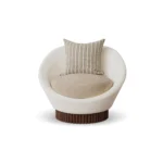 Anki contemporary armchair by Nolita Harbour, velvet upholstered chair with rounded form and sculptural wood base.