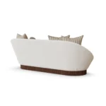 Anki contemporary sofa by Nolita Harbour, curved velvet seat with bouclé texture and ribbed walnut base, refined proportions.
