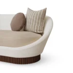 Anki curved sofa by Nolita Harbour in velvet and bouclé, upholstered sofa with walnut plinth and refined architectural silhouette.