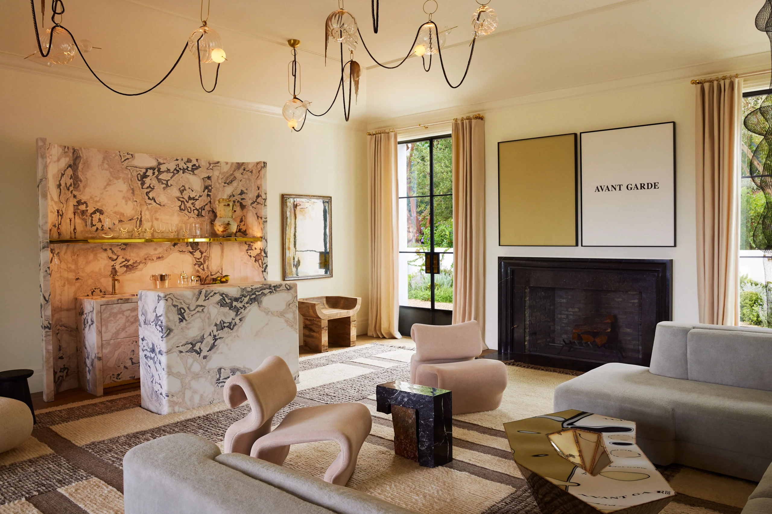 A modern living room with a minimalist aesthetic, featuring a marble bar, abstract furniture, and a neutral color palette. Large windows allow natural light to flow in, while contemporary chandeliers and avant-garde artwork add a sophisticated touch. - Nolita Harbour