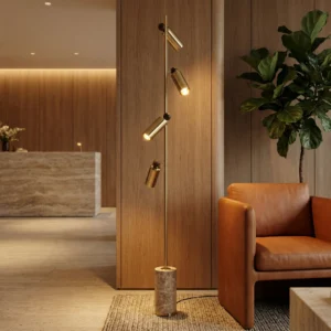 A Hotel lobby, with an area with the Alan floor lamp, by Nolita Harbour, iluminating a sofa and corner with its soft, directional glow.