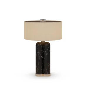 Arnaud Table Lamp. a refined table lamp by Nolita Harbour in Nero Marquina marble, metal, and fabric shade, casting soft light.