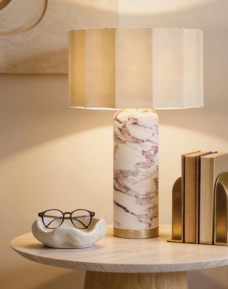 Standing on a luxury Elke side table, by Nolita Harbour, stands the luxury lamp with pleated fabric shade, the Beatrice table lamp.