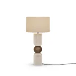 Christoph Table Lamp, a sculptural table lamp by Nolita Harbour in travertine, walnut, and fabric shade, casting a warm glow.