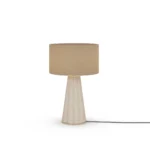 Filp Table Lamp, a sculptural table lamp by Nolita Harbour in fluted plaster, brass, and fabric shade, casting a soft glow.