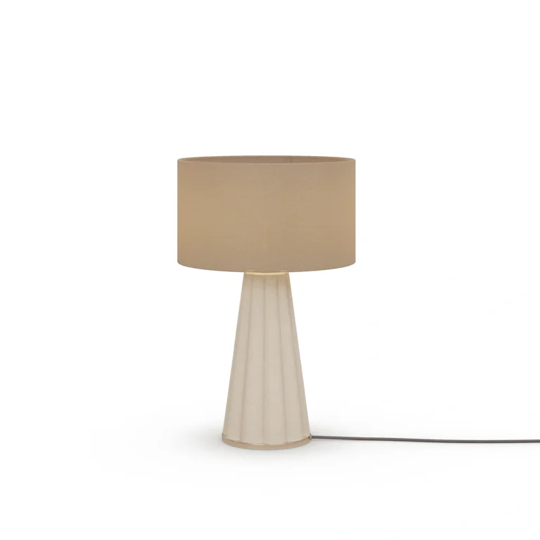 Filp Table Lamp, a sculptural table lamp by Nolita Harbour in fluted plaster, brass, and fabric shade, casting a soft glow.
