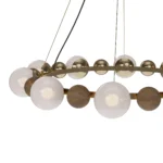 Laurent Suspension Lamp, an elegant suspension lamp by Nolita Harbour that combines brass, walnut, and glass for a balanced design.