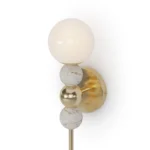 Longi Wall Lamp, a modern wall lamp by Nolita Harbour in marble, brass, and glass globe, offering soft ambient light.