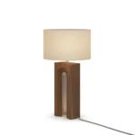 Louis Table Lamp, a sculptural table lamp by Nolita Harbour in walnut wood and fabric shade, casting a warm, even glow.
