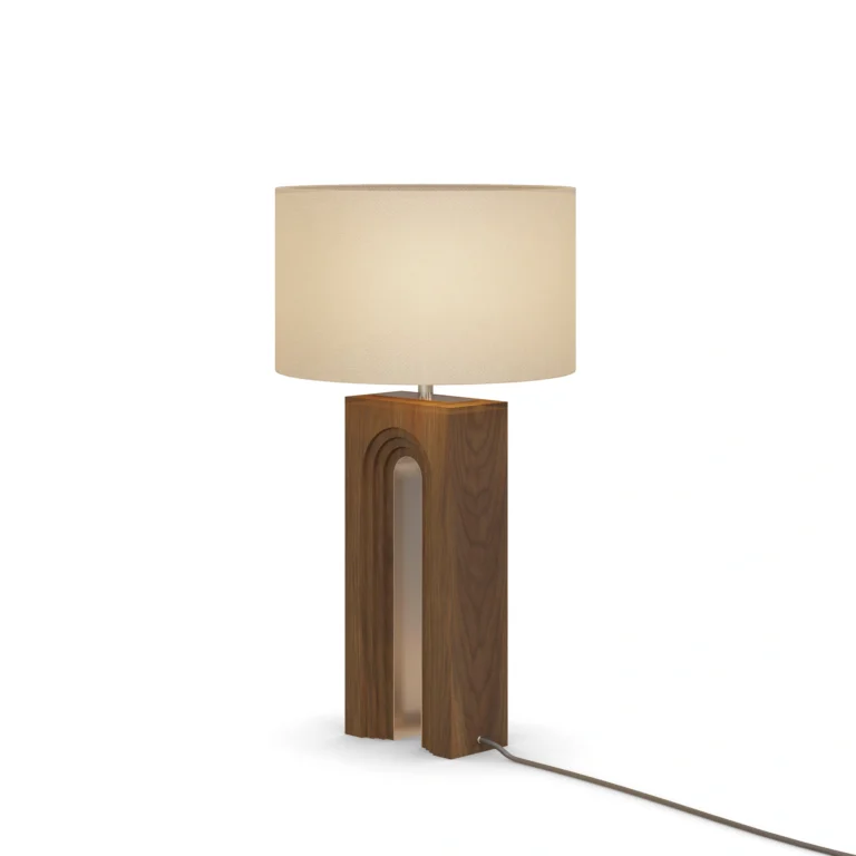 Louis Table Lamp, a sculptural table lamp by Nolita Harbour in walnut wood and fabric shade, casting a warm, even glow.