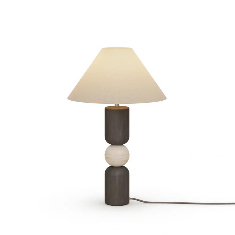 Luuk Table Lamp, a sculptural table lamp by Nolita Harbour in black wood, travertine, and fabric shade, casting a warm glow.