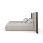 Sampson Bed contemporary bed by Nolita Harbour in velvet, walnut, and brass, showcasing a paneled headboard and tailored upholstery with precise joinery and elegant material contrast.