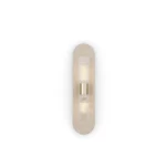 Taj Wall Lamp, an elegant wall lamp by Nolita Harbour in travertine, brass, and fluted glass, casting a soft ambient glow.