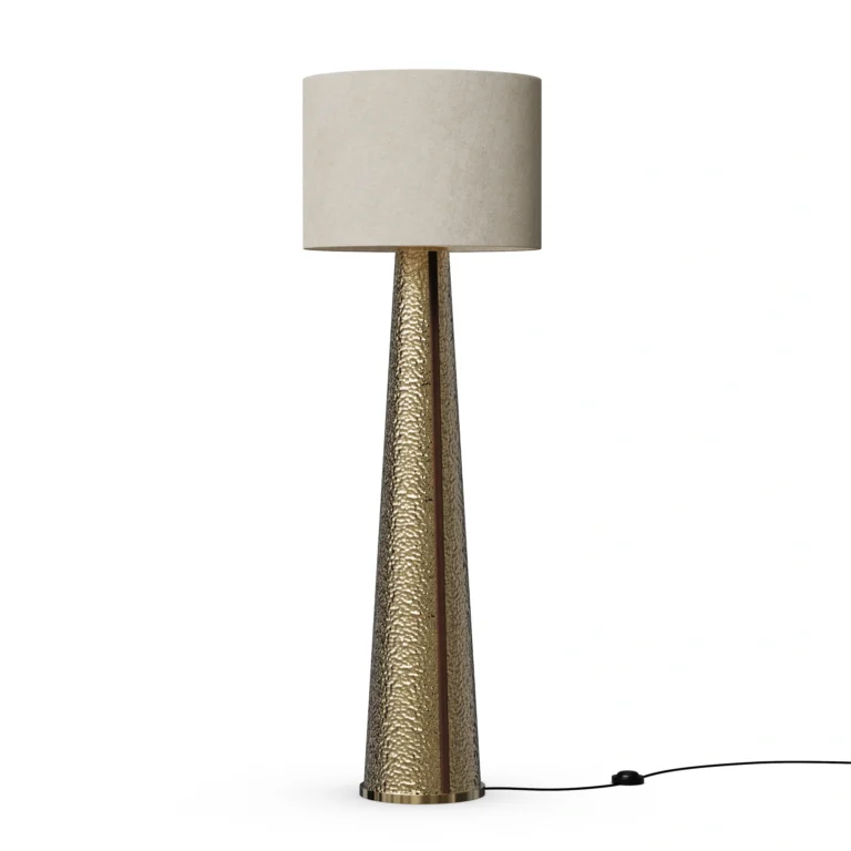 Yves Floor Lamp, a sculptural floor lamp by Nolita Harbour in hammered brass with fabric shade, casting a warm ambient glow.