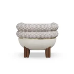 Amélie designer armchair by Nolita Harbour, sculptural bouclé armchair with walnut legs, brass band, and curved architectural form.