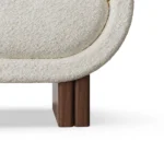 Amélie luxury armchair detail by Nolita Harbour, curved bouclé chair with layered upholstery and elegant walnut base.