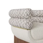 Amélie bouclé armchair detail by Nolita Harbour, luxury lounge chair with double-roll back, walnut base, and refined brass band.