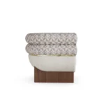 Amélie contemporary armchair by Nolita Harbour, bouclé lounge chair with double-roll back and refined brass detailing.