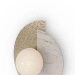 Detailed view of Noemi Wall Lamp wall lighting by Nolita Harbour crafted in Estremoz marble with brushed metal detailing and opal glass globe, minimalist luxury piece for corridors and lounge spaces.
