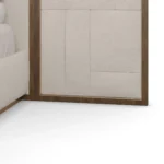 Hudson Bed, detailed view of upholstered bed by Nolita Harbour combining solid walnut structure with tailored fabric panels, a designer piece with geometric headboard and understated elegance.