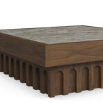 Close-up highlighting the arched carving details of the walnut base.