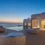 Luxury Villas of Mykonos with infinity pool overlooking the sea at sunset, featuring modern white architecture and outdoor lounge seating.”