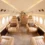 Luxury Travel private jet interior with leather seats, wood accents, and round windows offering an exclusive travel experience.