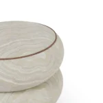 Details of Nolita Harbour Calie Stool, bespoke sculptural stool in patterned velvet and matte walnut wood, defined by organic rounded shapes and handcrafted detailing, with a textured finish that evokes natural stone aesthetics and enhances elegant, design-led living spaces. The image shows the upper left part of the calie stool.
