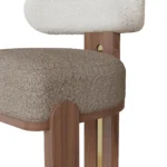 Diane luxury bar stool detail by Nolita Harbour, bouclé chair with sculptural curved back, walnut base, and polished brass.