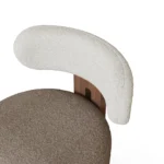Diane upholstered bar chair detail by Nolita Harbour, bouclé seat with walnut wood frame and brass accents, elegant modern style.