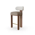 Diane bar chair by Nolita Harbour, bouclé bar stool with walnut base and brass details, sculptural curved-back design.