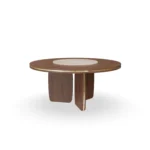 Assia Round Dining Table, an elegant dining table by Nolita Harbour in stone and solid wood, with a soft sculptural silhouette.