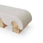 Corinne upholstered bench by Nolita Harbour, fabric bench with elongated silhouette and bold cylindrical legs, refined modern style.
