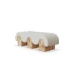 Corinne bench by Nolita Harbour, upholstered bench in textured fabric with rounded edges and cylindrical legs, sculptural design.