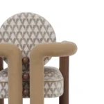 Maudine upholstered dining chair details by Nolita Harbour, patterned chair with sculptural round back and solid walnut base.